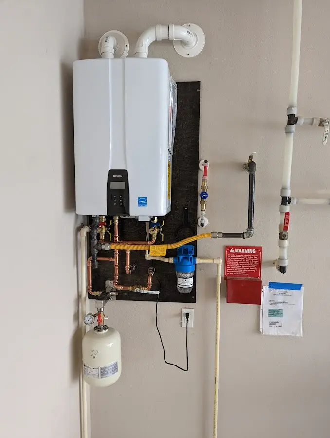 Professional plumber installing copper piping in a Fulton home